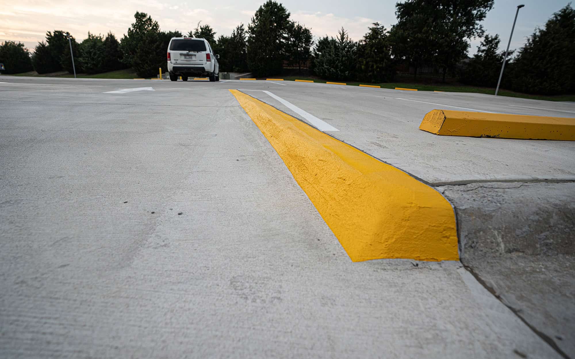 Front view of newly painted parking lot curb