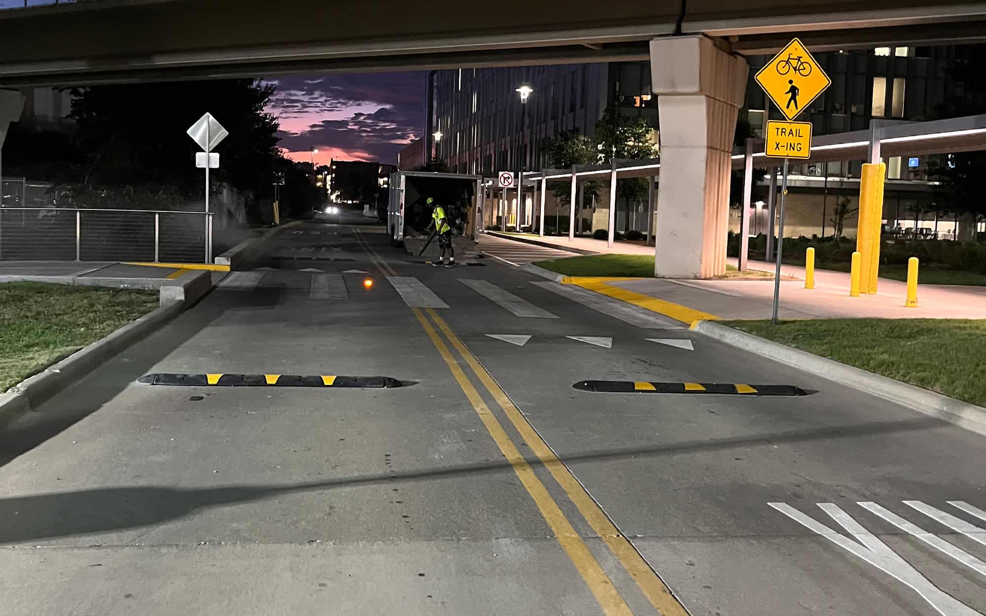 Front view of street at night with newly installed speed bumps