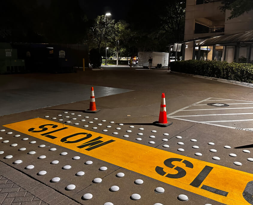 Side view of a parking lot at night with newly installed accessories