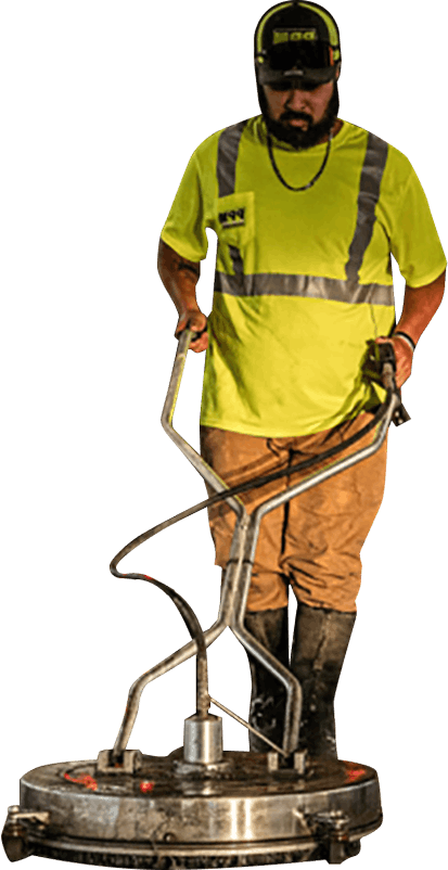 A bearded worker in a PPM uniform operates a floor cleaning machine