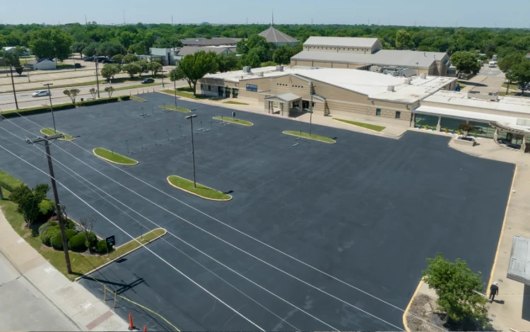 Aerial view of a freshly paved, lined parking lot