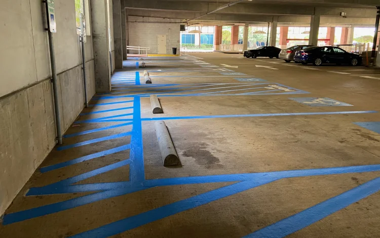 Empty indoor parking garage with blue lines marking