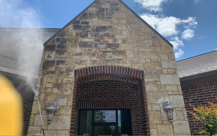 The stone building exterior is pressure washed