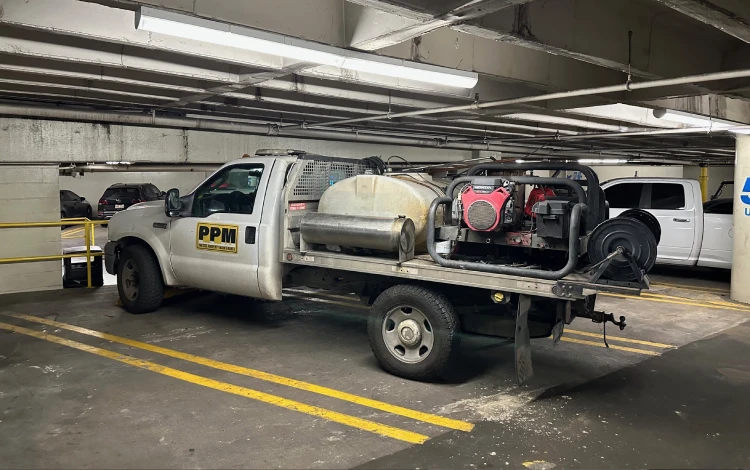 White PPM utility truck with equipment in a dim garage White PPM utility truck with equipment in a dim garage