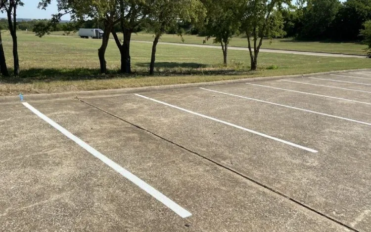 An empty parking lot with faded white lines