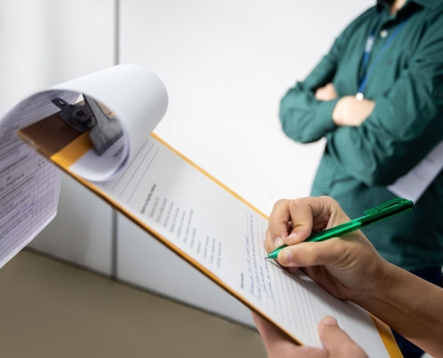 person looking at a checklist (on a clipboard)