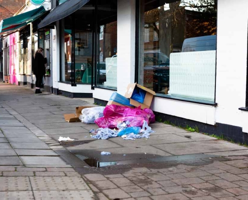 trash and debris pile-up outside of a commercial establishment